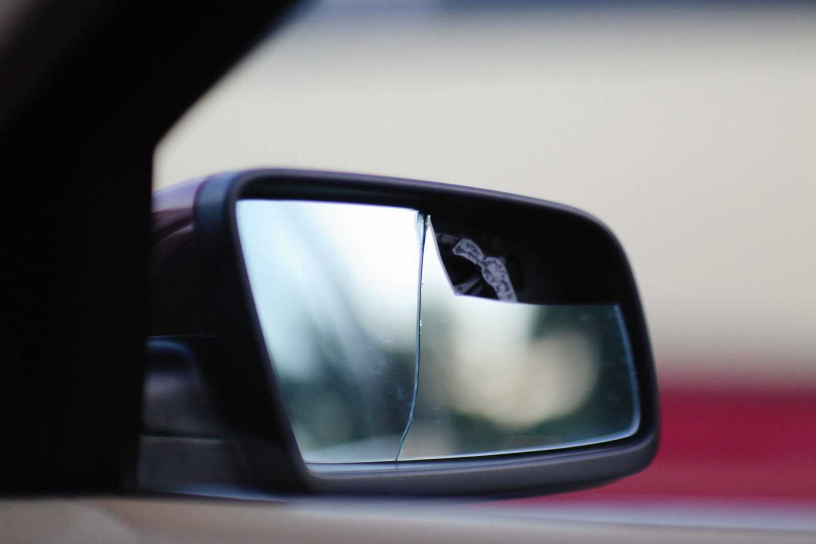 Cracked side mirror on a car after an accident